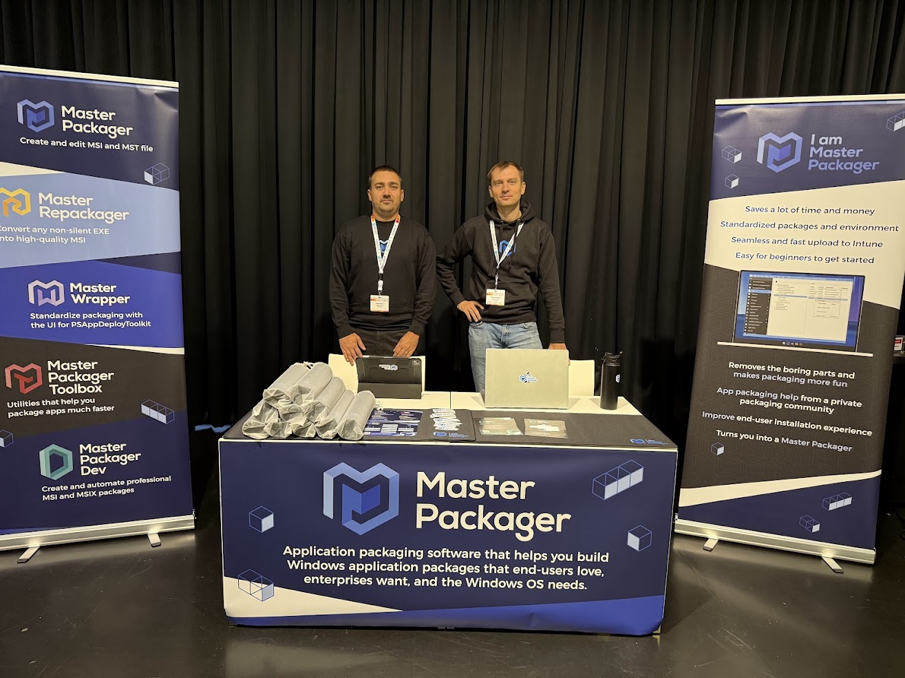 Edijs Perkums and Toms Knostenbergs behind the Master Packager booth.
